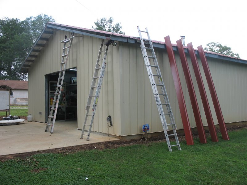 Build Backyard Workshop
 Installing building trim on gable overhang