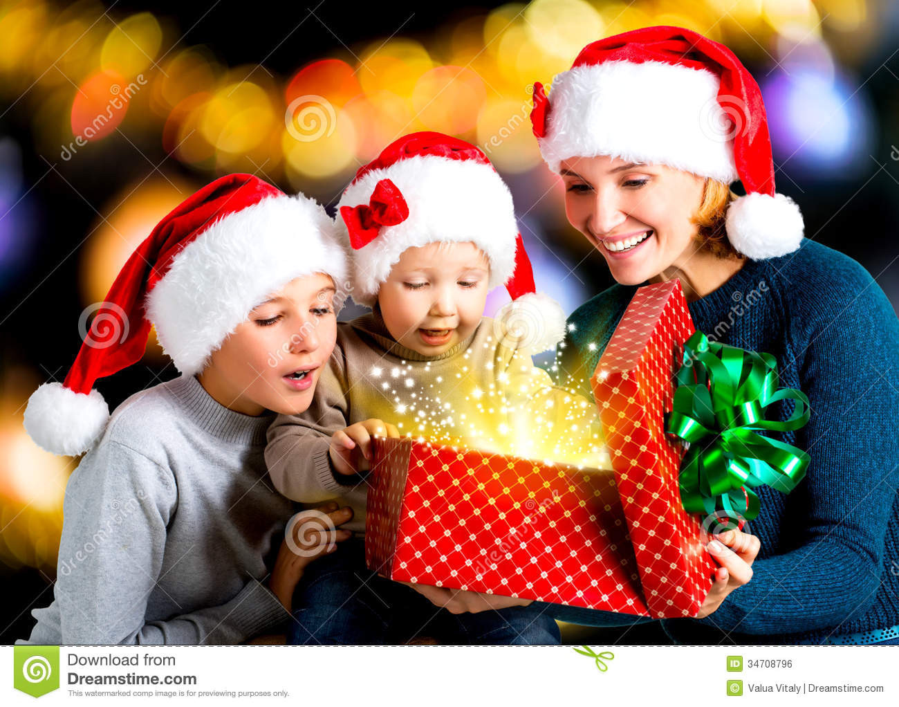 Children Gift
 Mother With Children Opens The Box With Gifts The