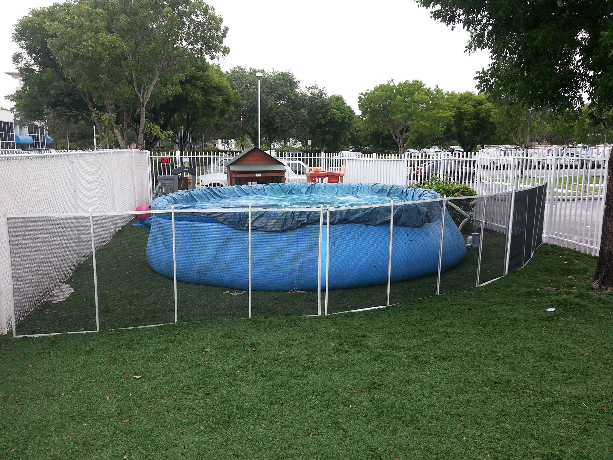 Fence Around Above Ground Pool
 black mesh pool fence with white poles installed in grass