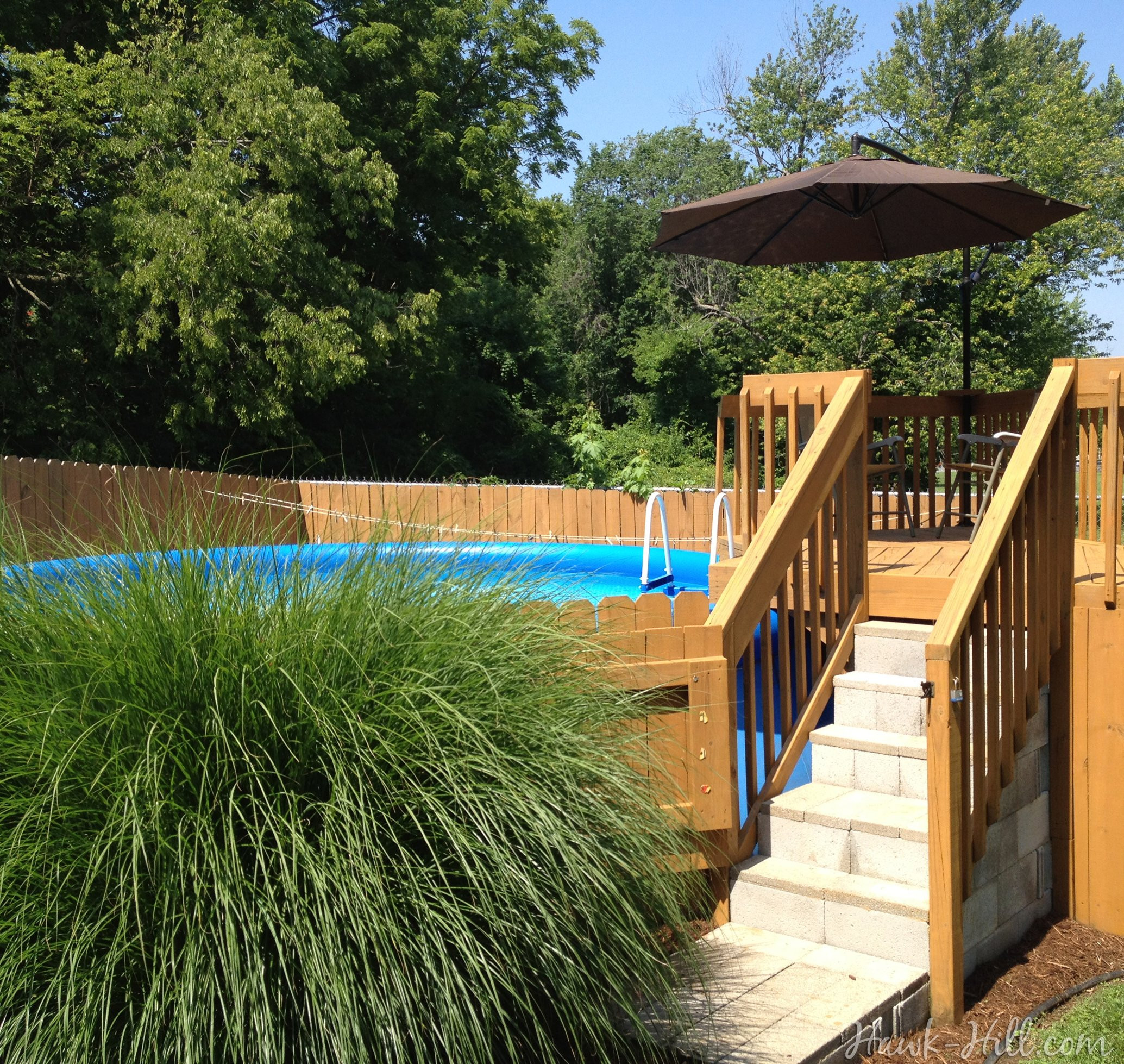 Fence Around Above Ground Pool
 Hiding a Big Blue Ground Pool in a Landscaped