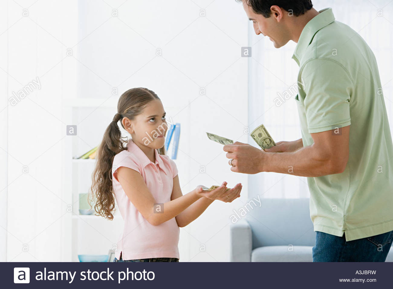 How To Gift Money To Child
 Father giving daughter pocket money Stock Royalty