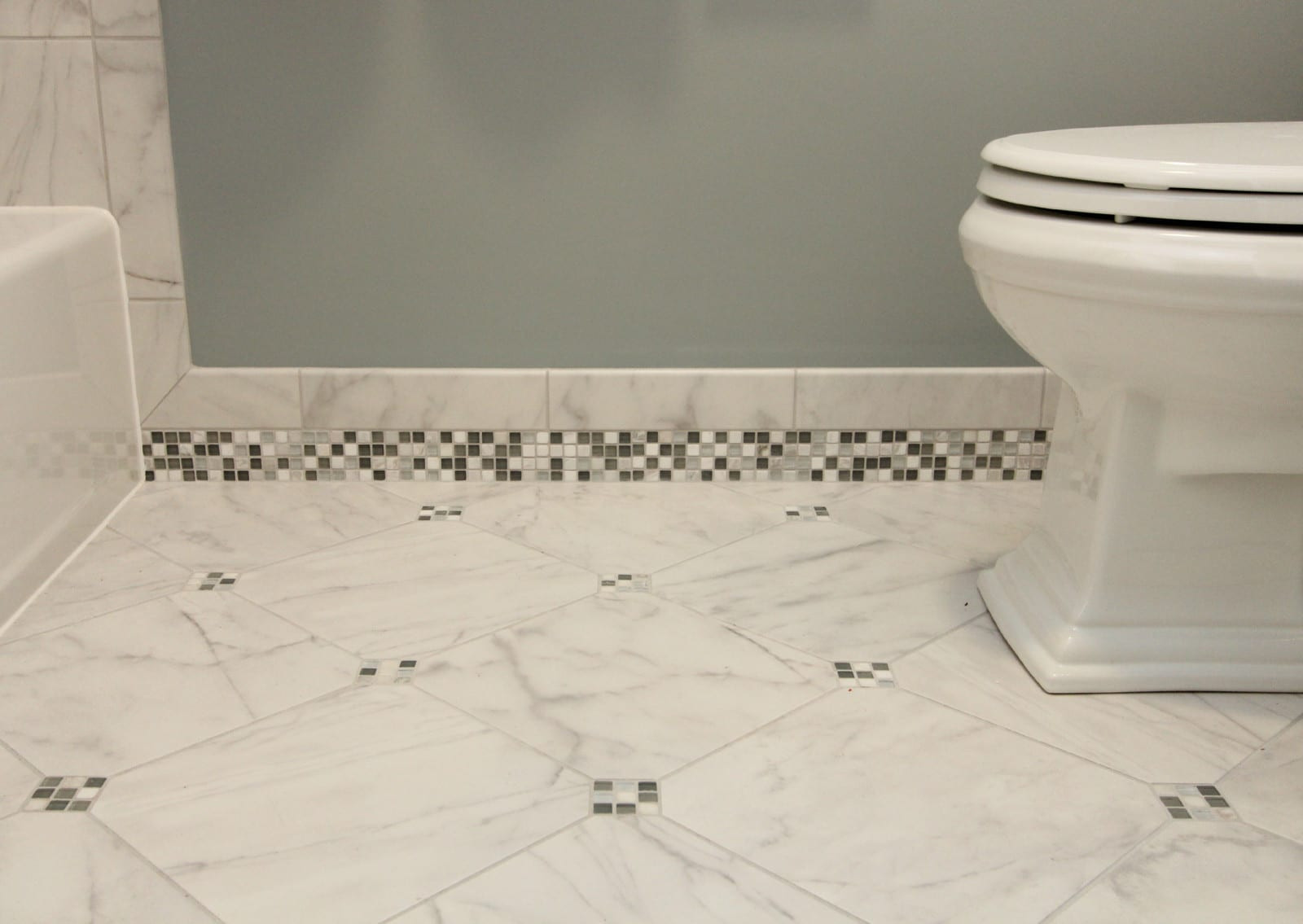 Tile Baseboard In Bathroom
 Bathroom Renovation Cool Tones with Mosiac Tile Baseboards